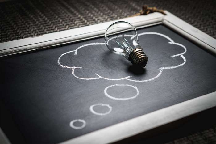 Lightbulb in a thought bubble on a blackboard