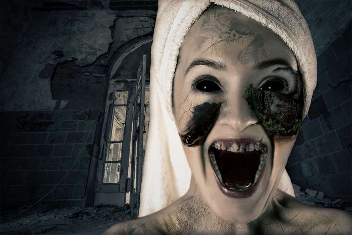 Demonic woman with black eyes in a ruined building