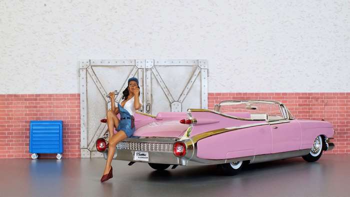 Pin-up mechanic with pink Cadillac Eldorado