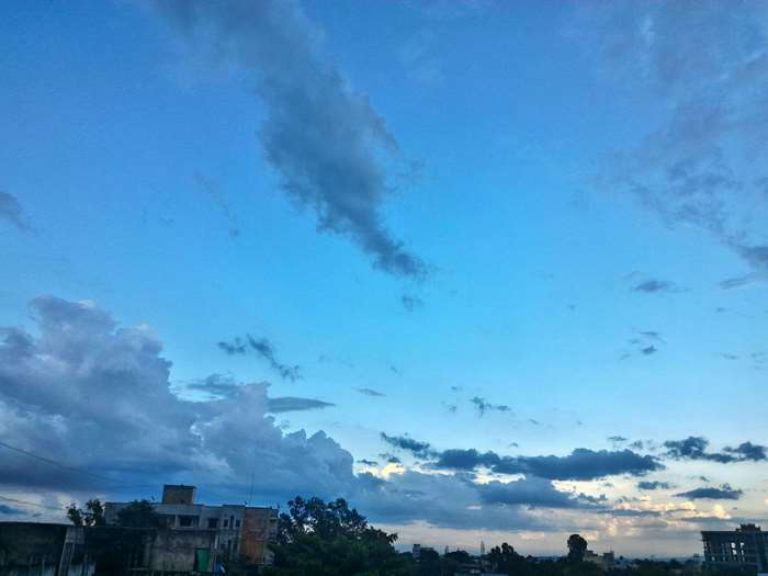 Blue sky with clouds over buildings