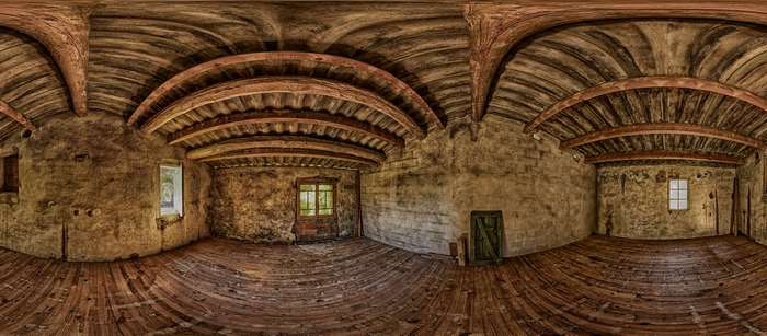Abandoned old house interior with wooden beams and stone walls