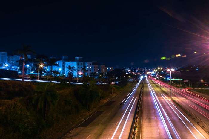 Long exposure of a highway at night with city lights