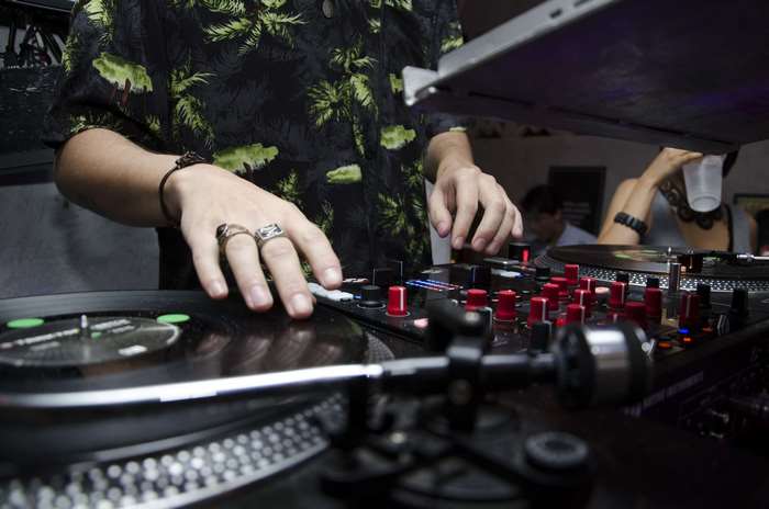 DJ performing with turntable and mixer