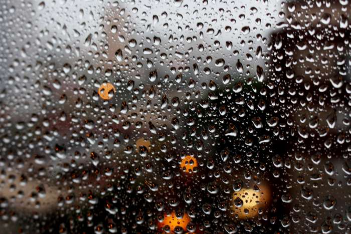 Raindrops on a window with bokeh lights