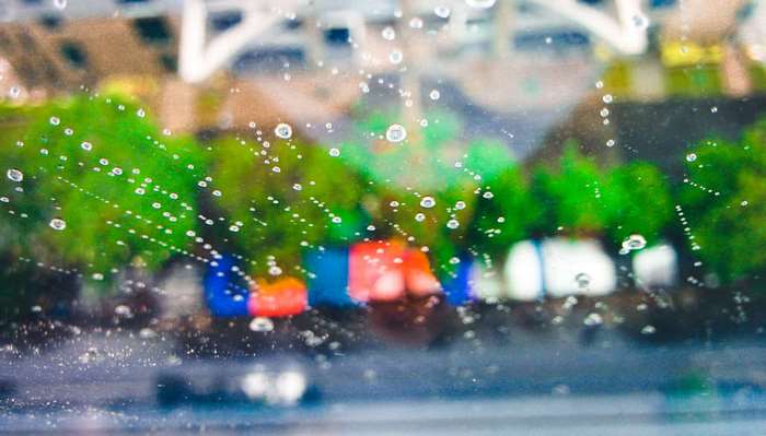 Raindrops on a window with blurred background
