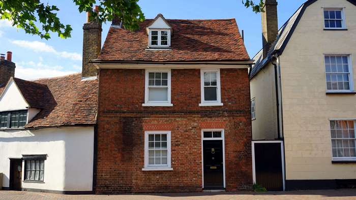 Brick and white houses with tiled roofs and windows