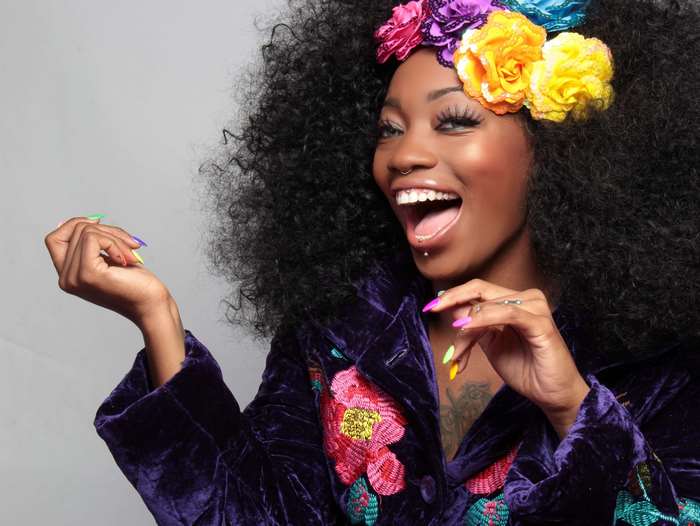 Woman with Afro and Flower Headwear