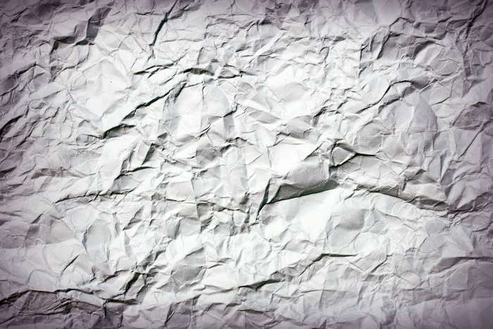 Crumpled paper texture with shadows and highlights