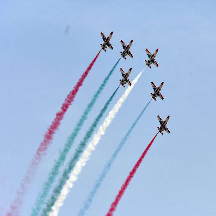 Pakistan Air Force jets performing aerobatics with colored smoke