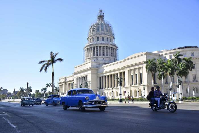 Vintage cars and motorcycle in front of El Capitolio, Havana, Cuba