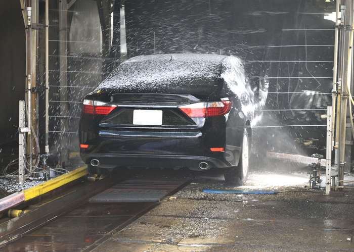 Black car being washed at a car wash