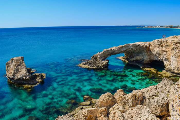 Natural rock arch over turquoise sea in Cyprus