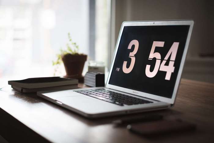 Minimalist Laptop Display Showing Time on Desk
