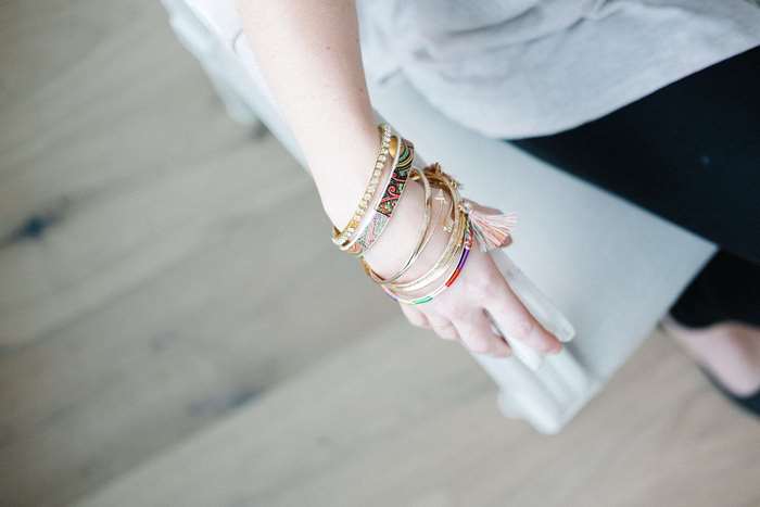 Woman's arm with multiple bangles and bracelets