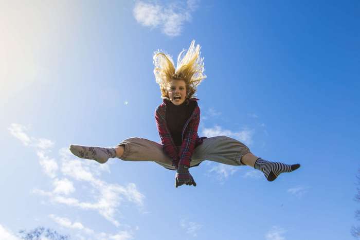 Girl jumping in the air with legs split