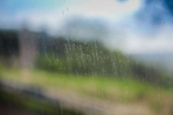 Dirt on a glass window with nature background