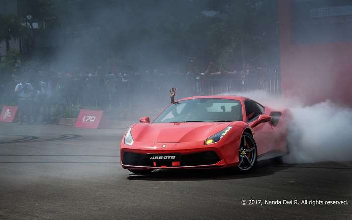 Red Ferrari 488 GTB drifting with smoke