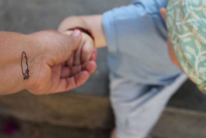Mother and son holding hands with a tattoo