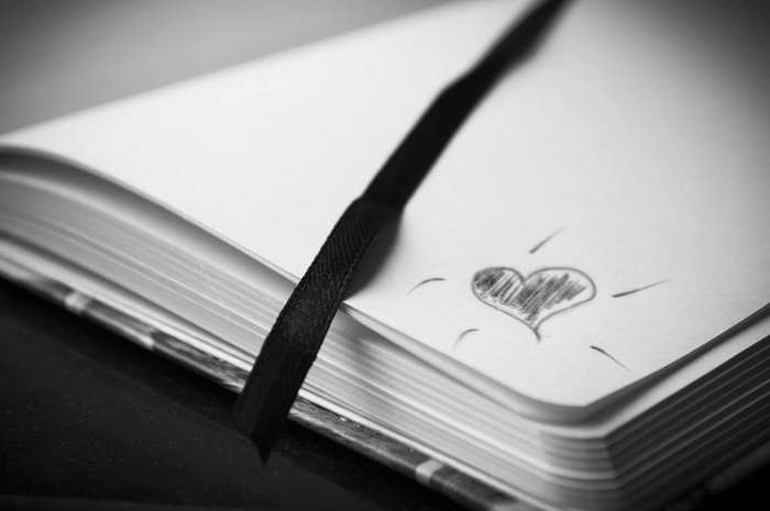 Black and white sketch of a heart in a notebook
