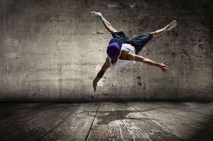 Man breakdancing in a warehouse