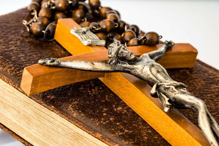 Crucifix and Rosary Beads on a Book
