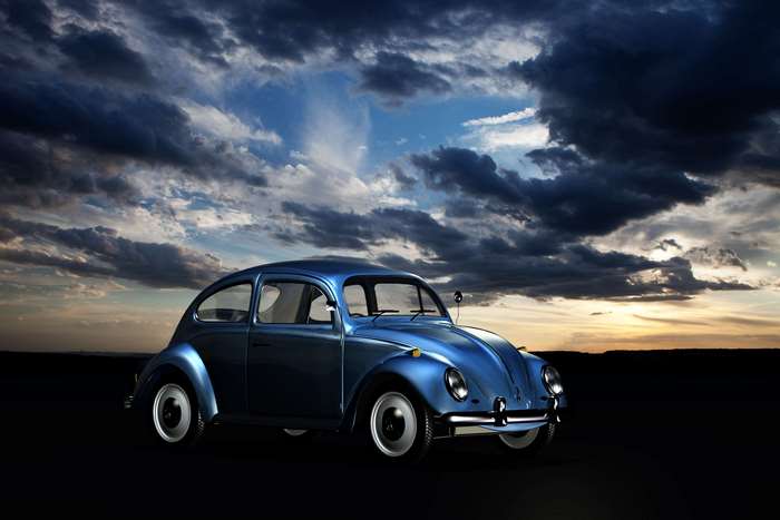 Blue Volkswagen Beetle car under dramatic clouds