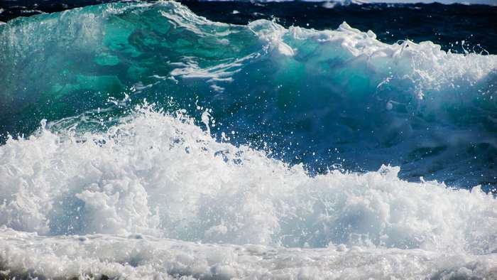 Ocean wave crashing with seafoam