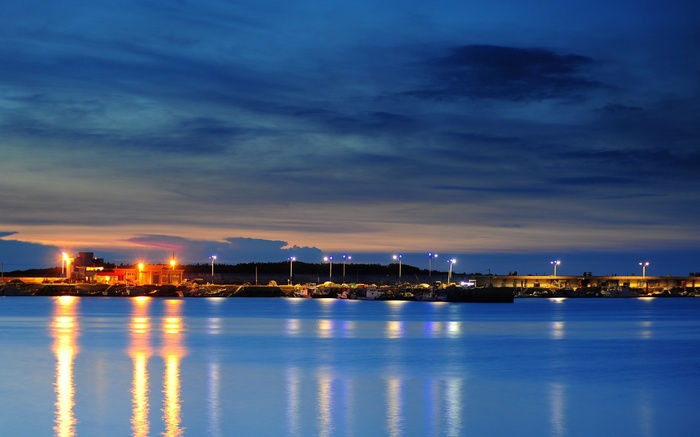 Harbor at dusk with reflections on water