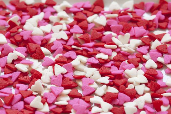 Close up of heart-shaped sprinkles in red, pink, and white