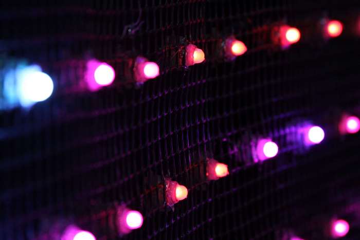Close-up of LED lights on a dark grid