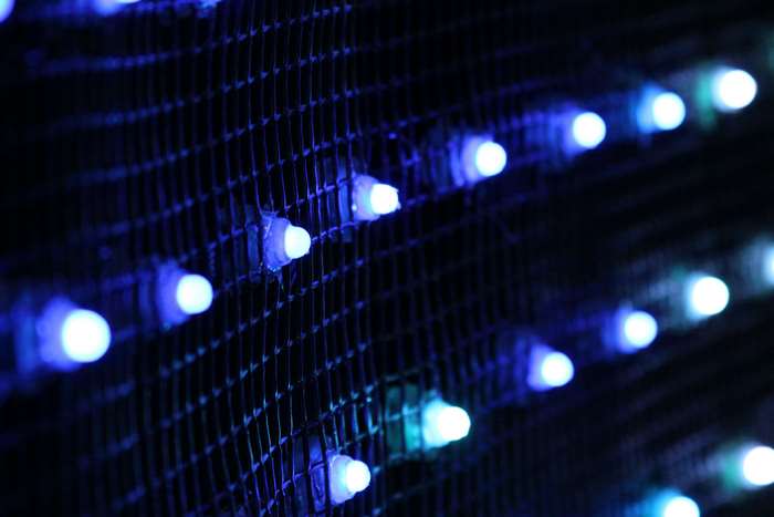 Blue LED lights on a dark grid