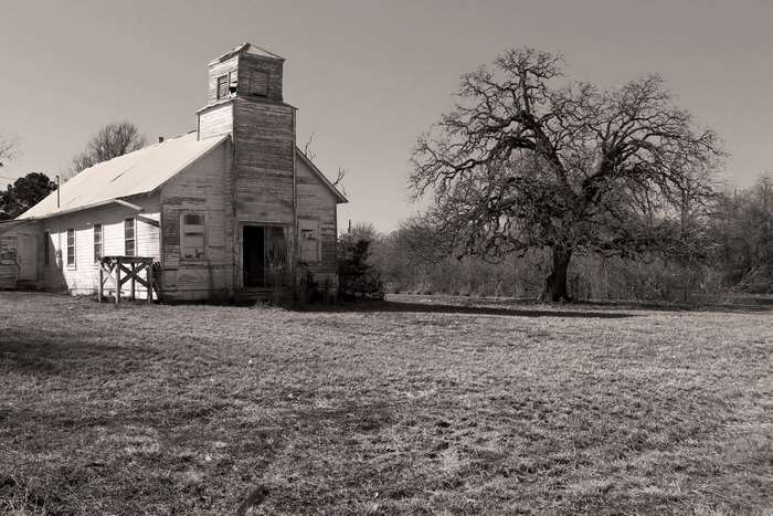 Abandoned church and dead tree in black and white