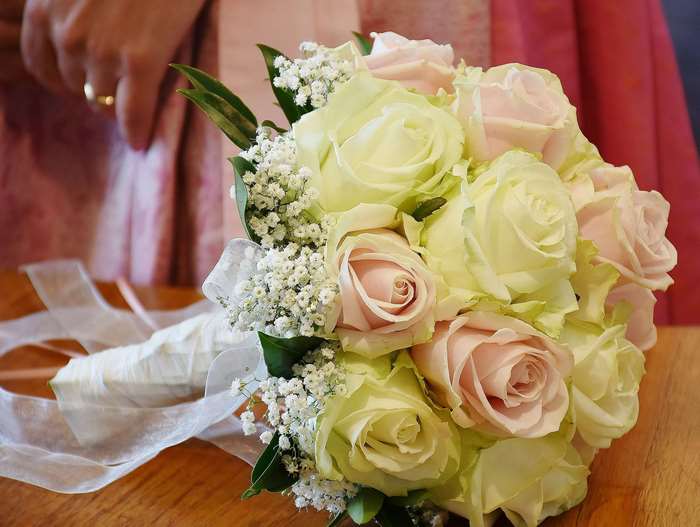 Wedding bouquet of pink and white roses with ribbons