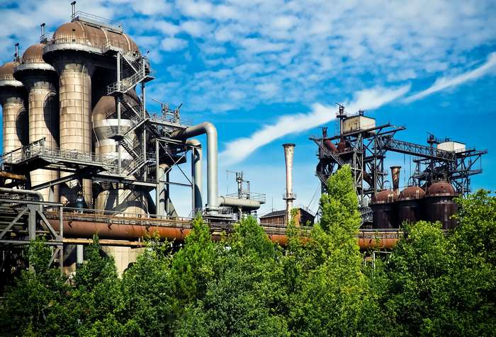 Industrial plant with blast furnaces and trees