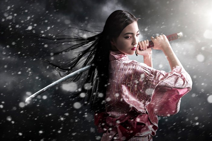 Woman in Kimono holding a Katana sword