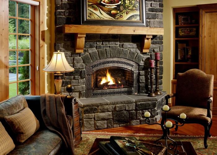 Living room with fireplace, sofa, chair, and lamps