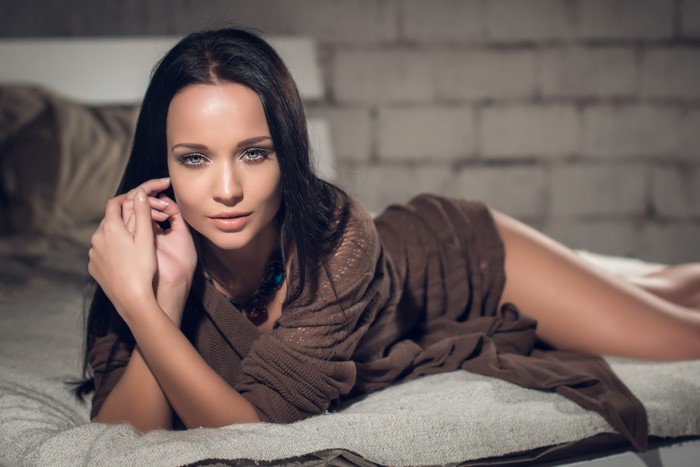 Angelina Petrova Relaxing on Bed in Brown Sweater