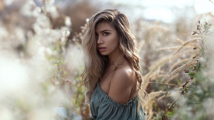 Woman with long blonde hair in a field