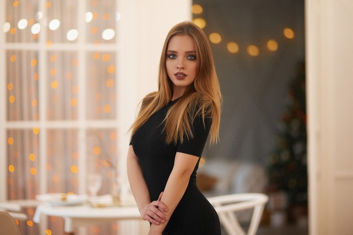 Woman in black dress with bokeh lights