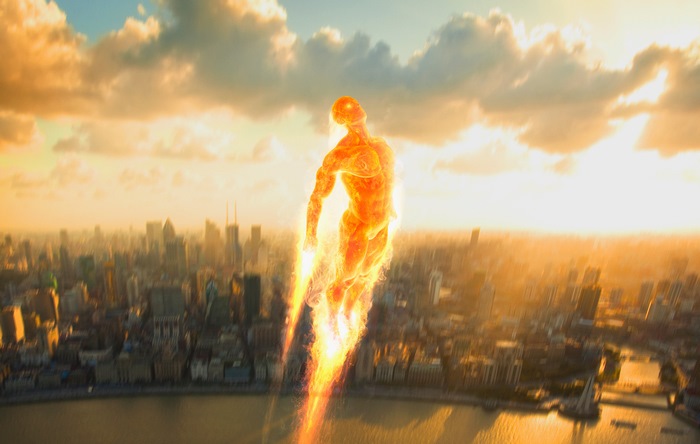 Human Torch flying over a city at sunset