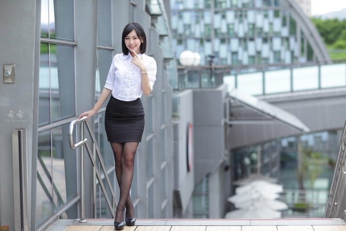 Elegant Woman in White Shirt and Black Skirt