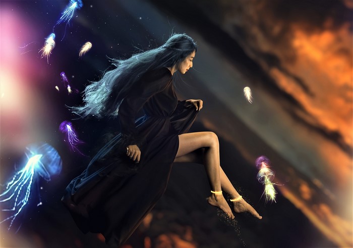 Asian woman floating with jellyfish