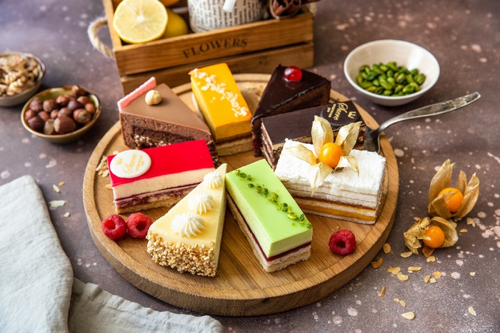Assorted Colorful Pastry Cakes on Wooden Platter
