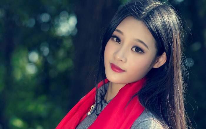 Asian woman with black hair and red scarf