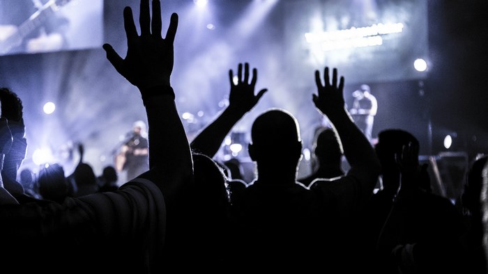 Crowd with hands raised at a concert