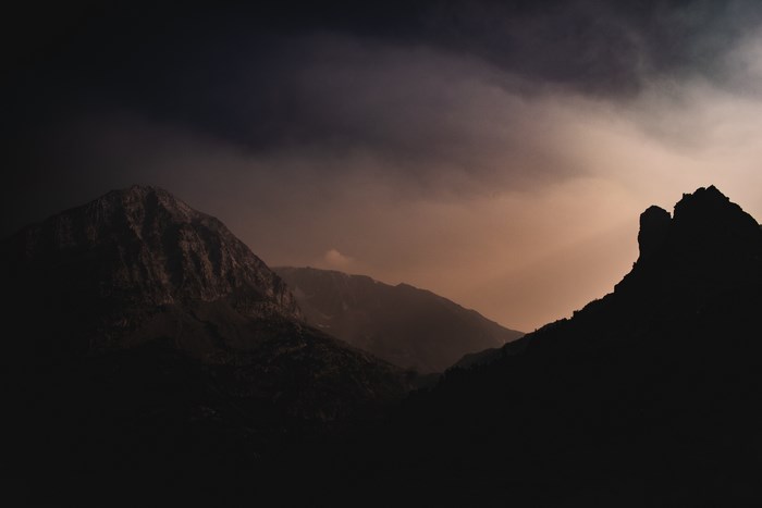 Mountain range at dusk with dramatic clouds