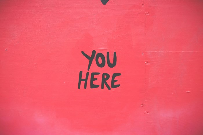 You Here sign on red wall
