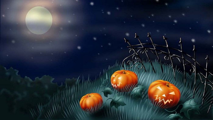 Halloween night with carved pumpkins and a full moon