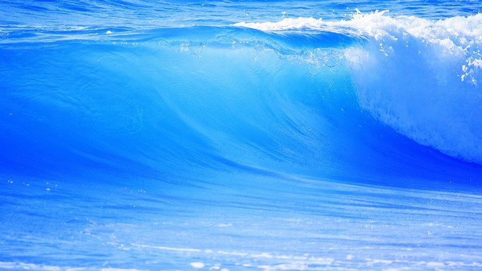 Ocean wave crashing with white foam