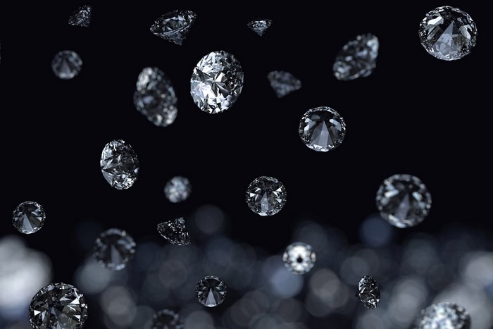 Diamonds falling on black background